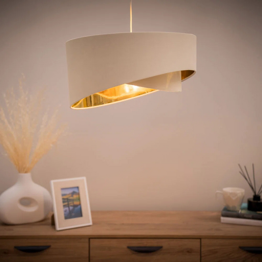 Beige pendant lamp hanging above a wooden console table with decorative items.