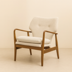 Wooden armchair with beige cushion on a beige background