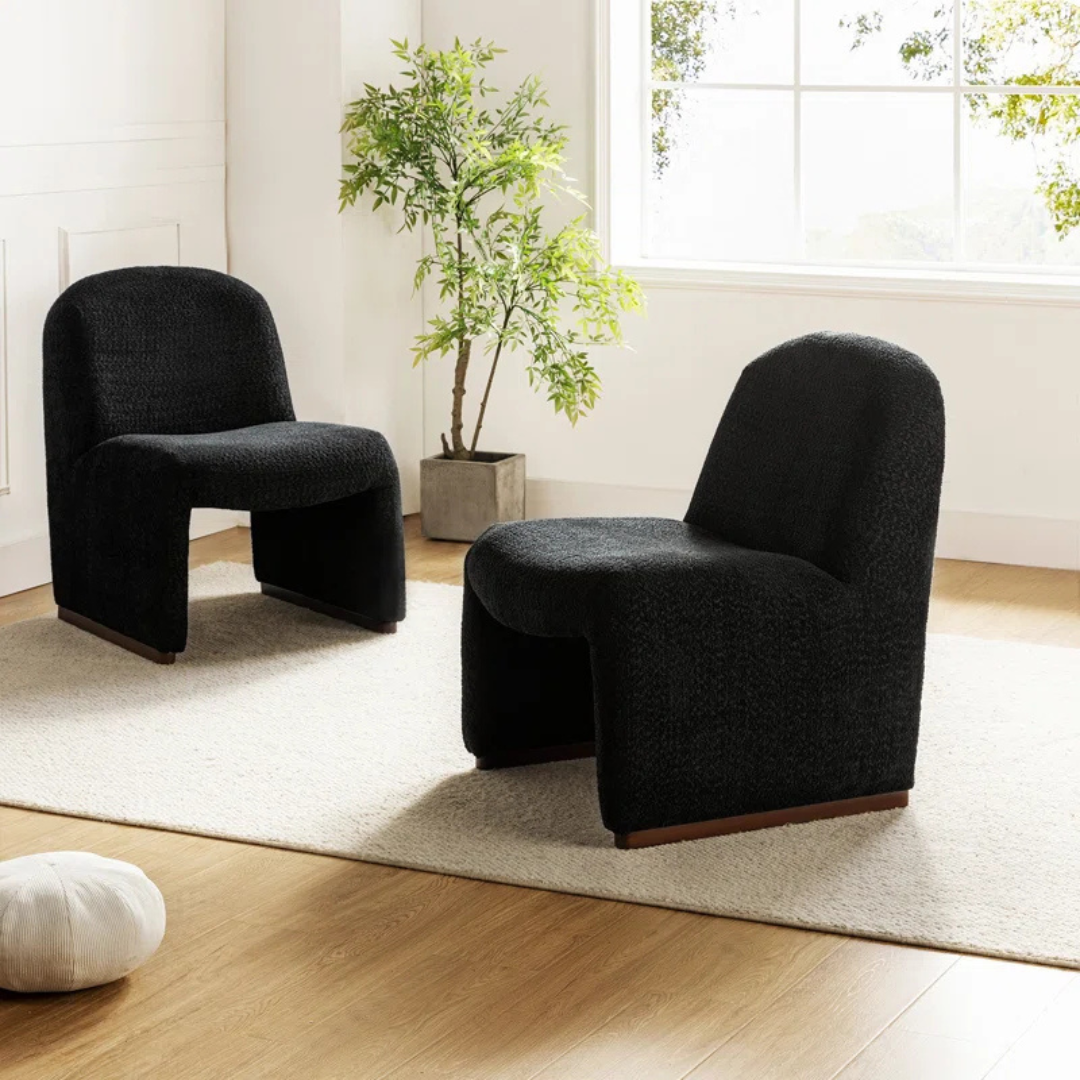 Pair of black boucle funky accent chair with curved design in a modern living space.