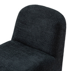 black boucle funky accent chair with curved design, close up to boucle design.