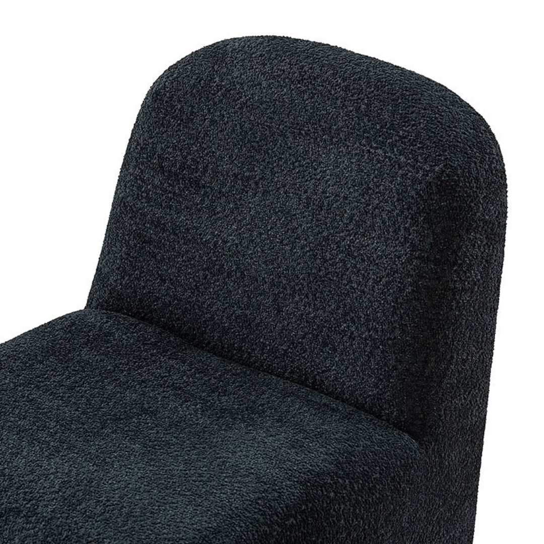 black boucle funky accent chair with curved design, close up to boucle design.
