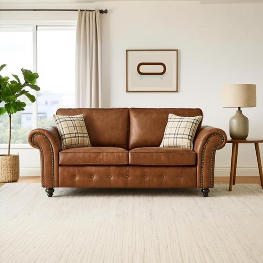Brown leather sofa with plaid cushions in a living room setting.