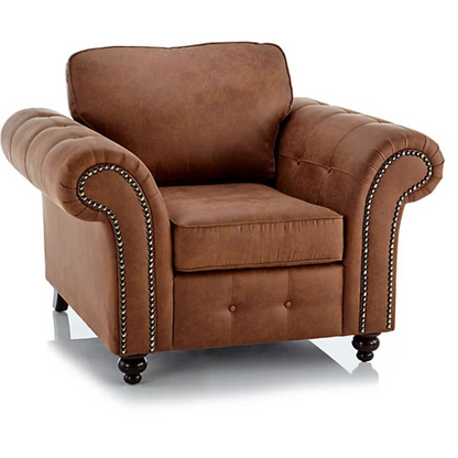 Brown leather armchair with tufted backrest and nailhead trim on a white background