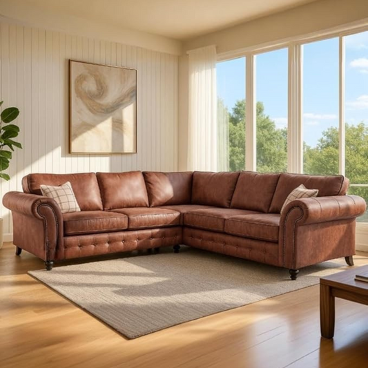 Brown leather sectional sofa in a living room with large windows and a plant.