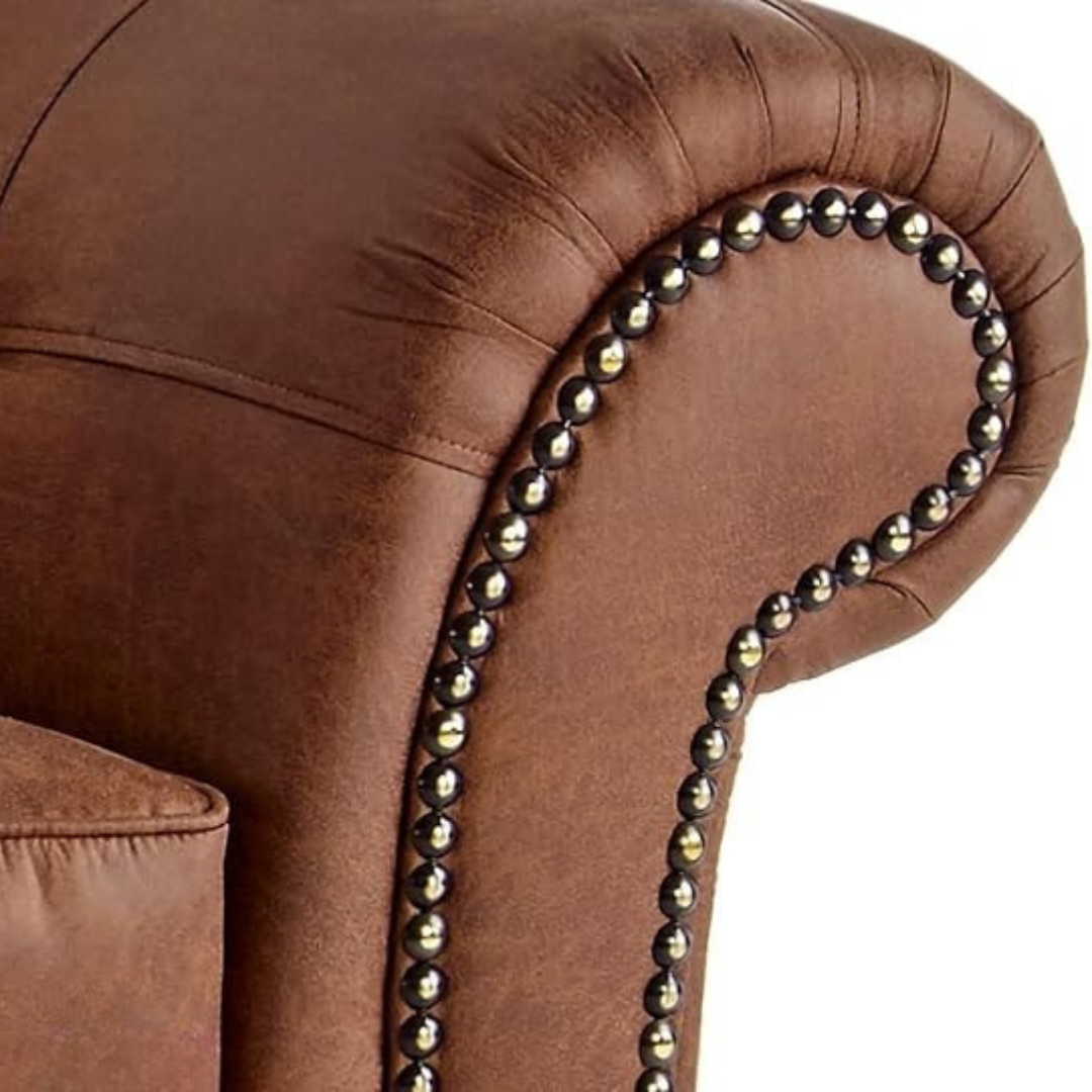 Brown leather armchair with decorative nailhead trim on a white background