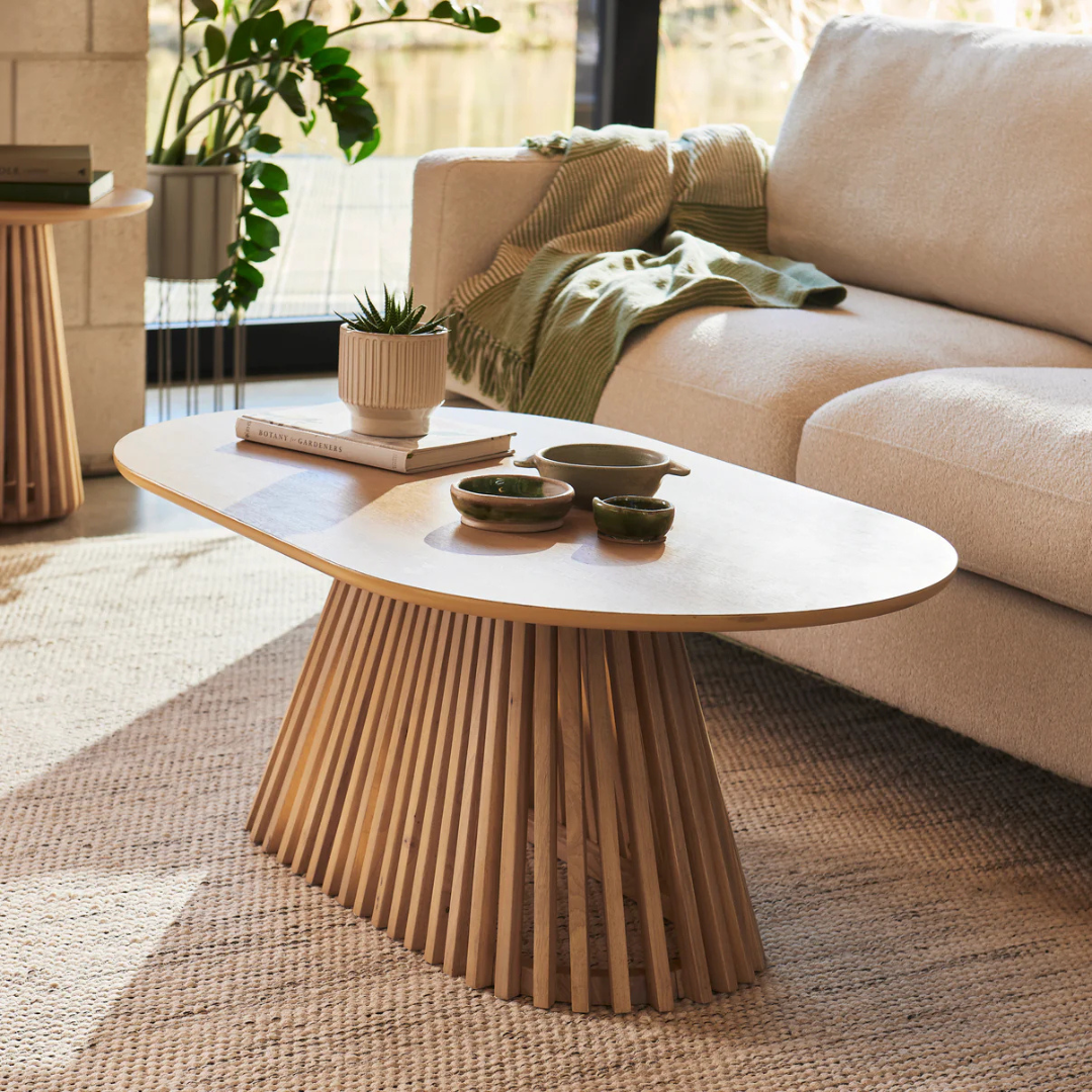 Ciera Oval Wood Coffee Table-Light Oak, set in a modern home. side view.