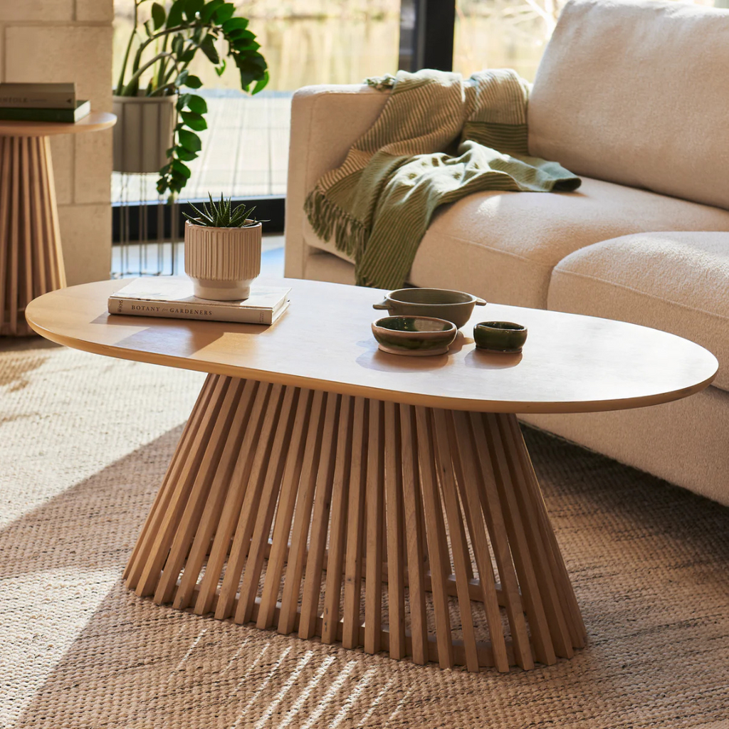 Ciera Oval Wood Coffee Table-Light Oak, set in a modern home, angled view.