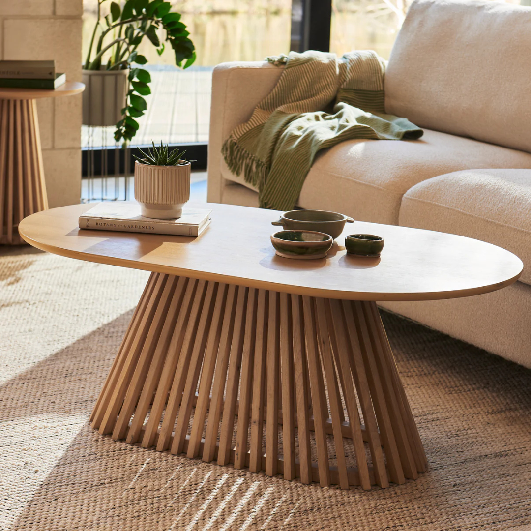 Ciera Oval Wood Coffee Table-Light Oak, set in a modern home, angled view.