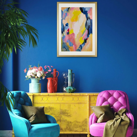 Colorful living room with blue and pink chairs, yellow cabinet, and abstract art on a blue wall.
