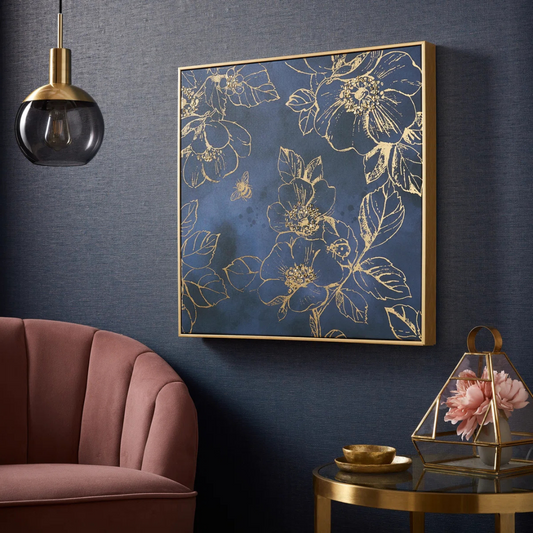 Floral artwork on a dark blue wall with a pink sofa and small table in the foreground.