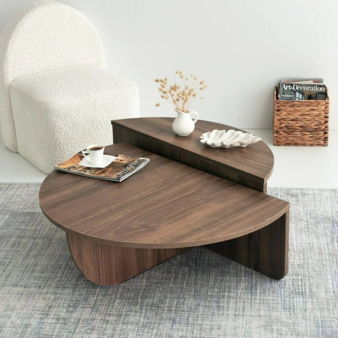 Contemporary low round coffee table with magazine slot, brown table set in a modern home, top view.