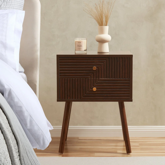Walnut Wooden bedside table with geometric design next to a bed in a bedroom setting