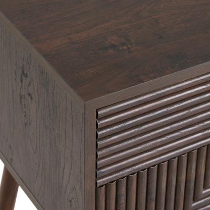 Close-up of a wooden side table with a textured surface and geometric design. close up