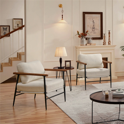 pair of modern white boucle accent chair with wood arms and metal frame, set in a modern living room.