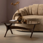 Beige sofa with a glass coffee table in a living room setting