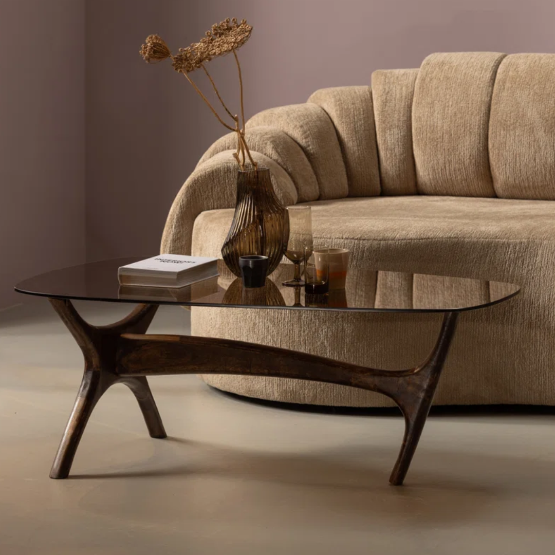 Beige sofa with a glass coffee table in a living room setting