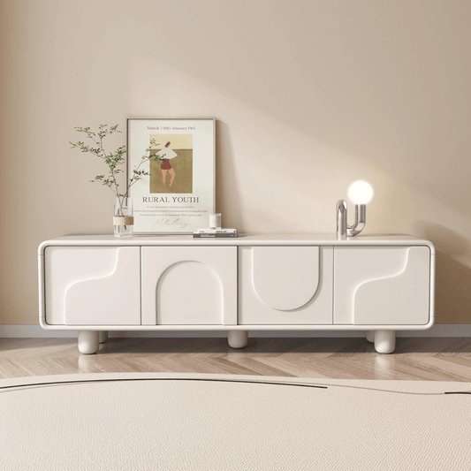 Modern white entertainment console with decorative items against a beige wall.
