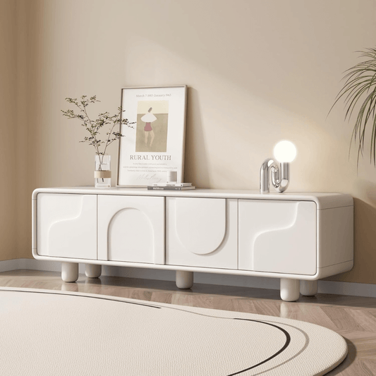 White TV stand with decorative items in a living room setting