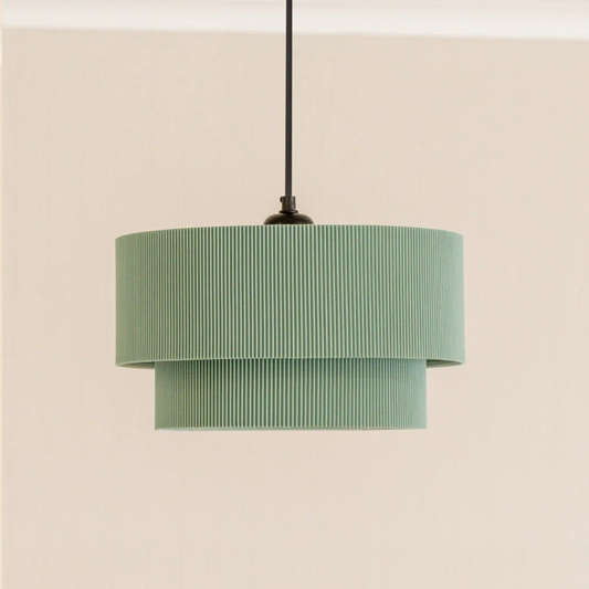 Green pendant lamp with striped design on a beige background