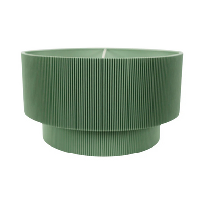 Green ribbed planter on a white background