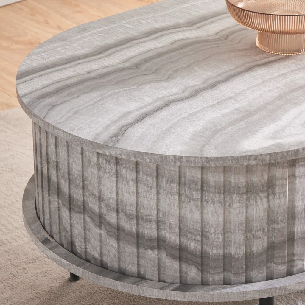 Grey marble effect oval coffee table with fluted base, close up to design.