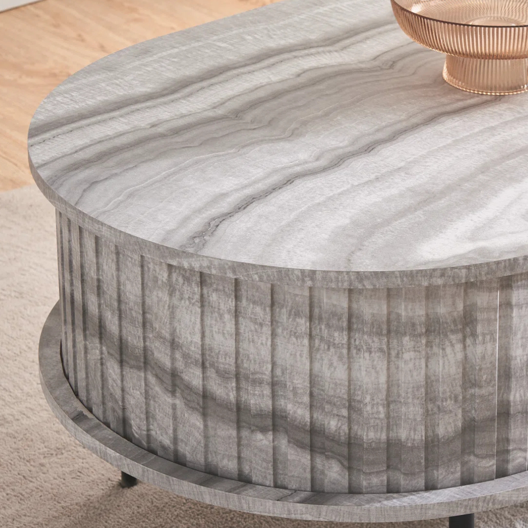 Grey marble effect oval coffee table with fluted base, close up to design.