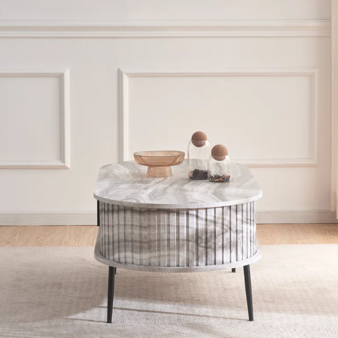 Grey marble effect oval coffee table with fluted base, in a modern home, side view.
