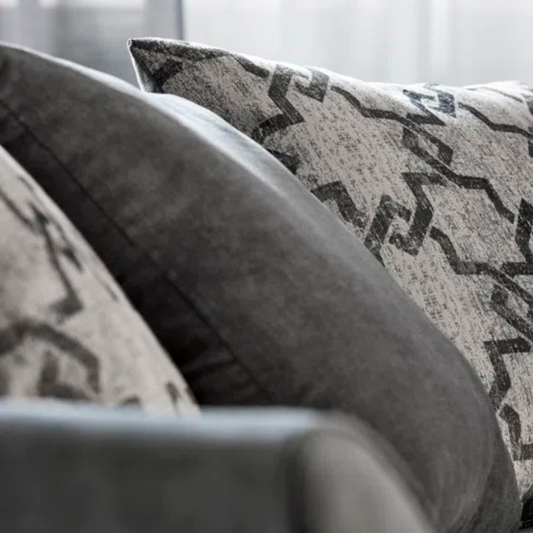 Grey Modern Corner Sofa With Pillows, white background, close up of cushions.