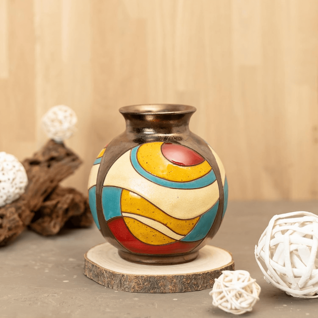 Decorative vase with colorful patterns on a wooden base against a beige background