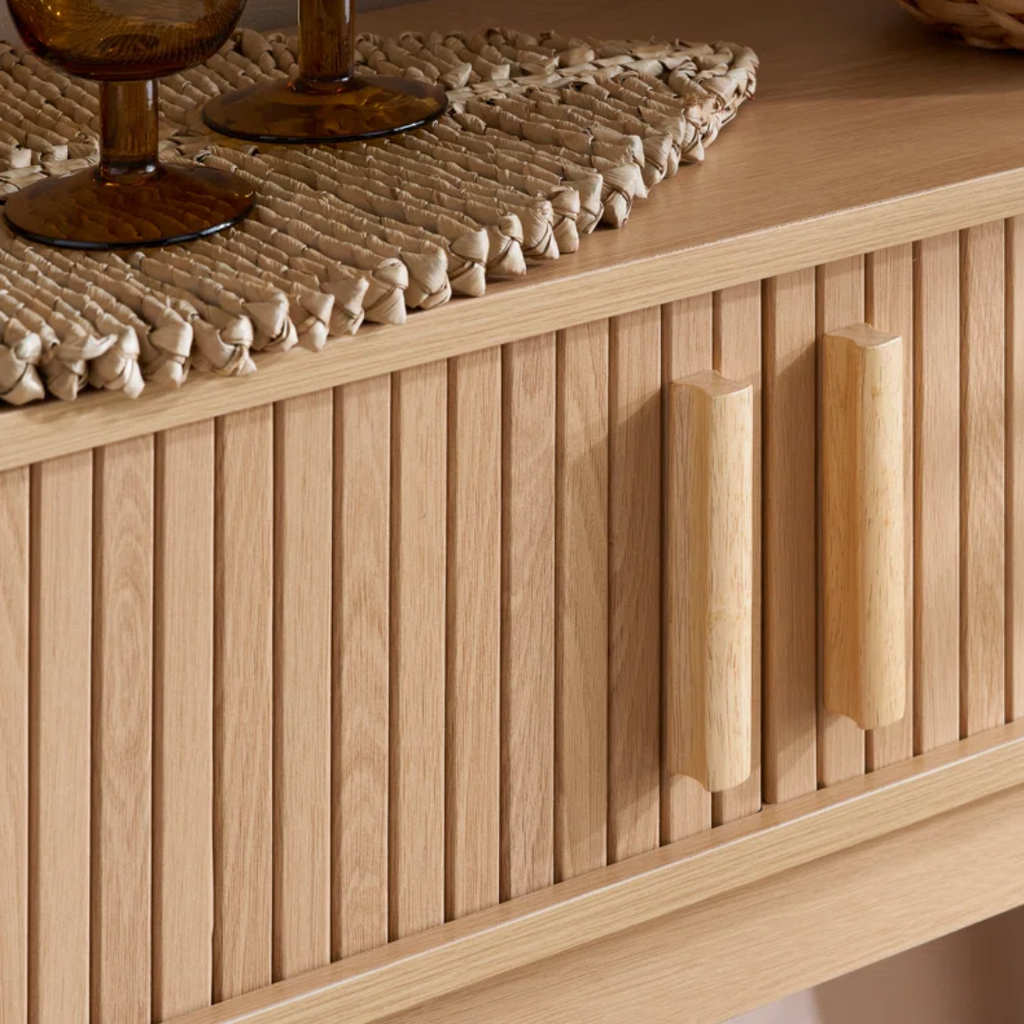 Wooden console table with a textured surface and decorative items on top