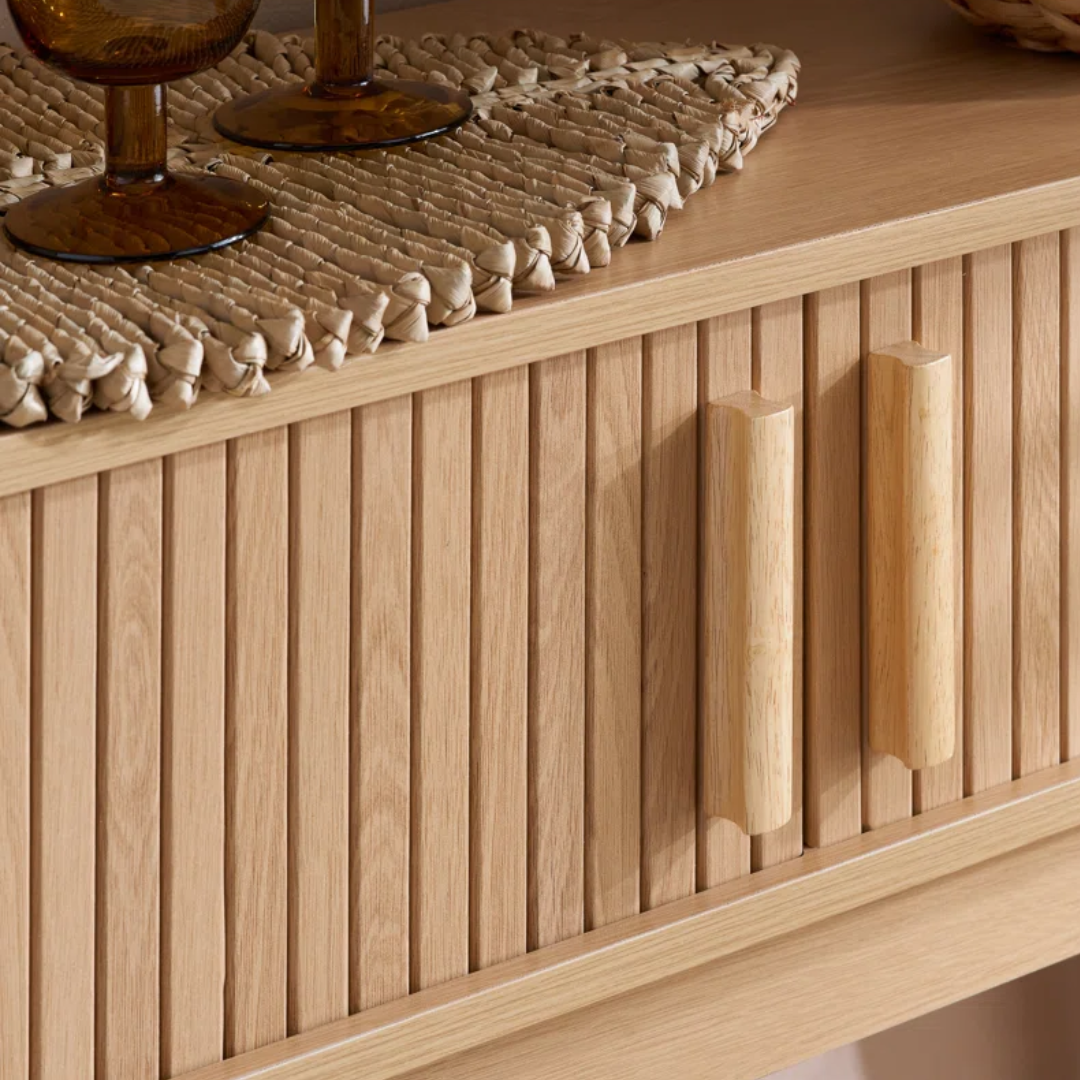 Wooden console table with a textured surface and decorative items on top