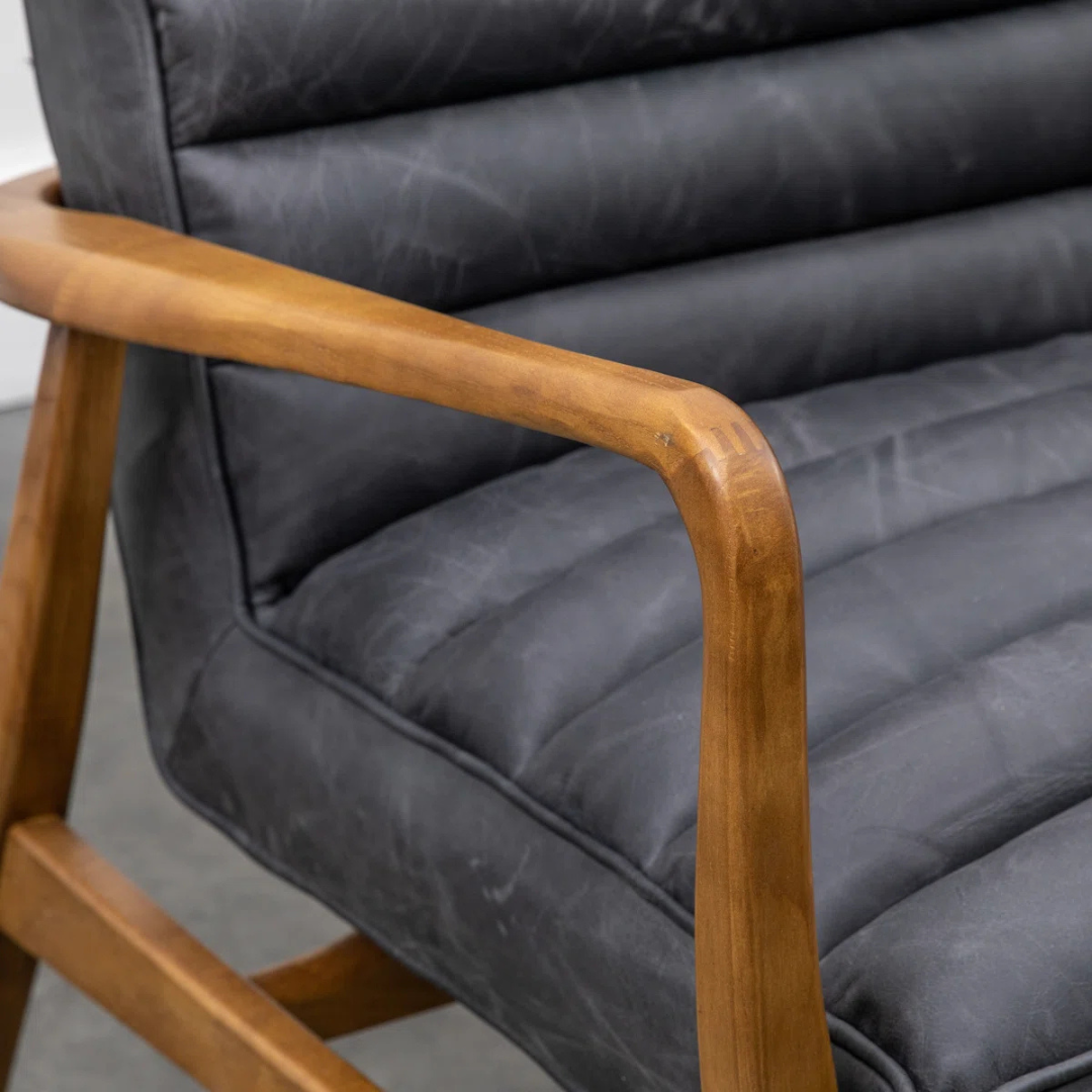 Gray cushioned chair with wooden armrests on a plain background