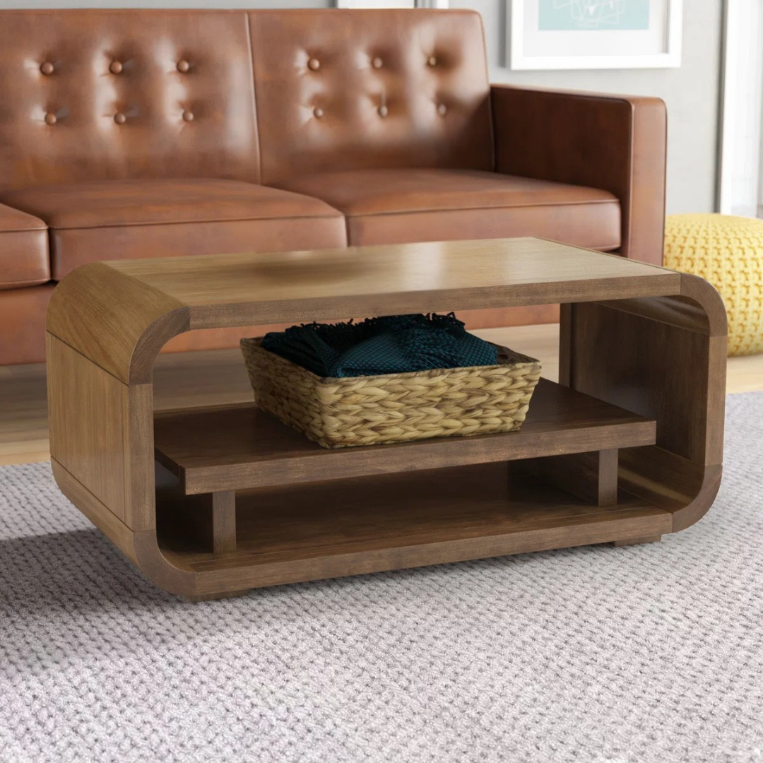 Mango wood curve coffee table with rounded edges, set in a mid century home.