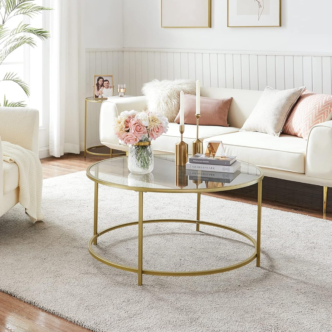 Living room with a white sofa, gold coffee table, and decorative items.