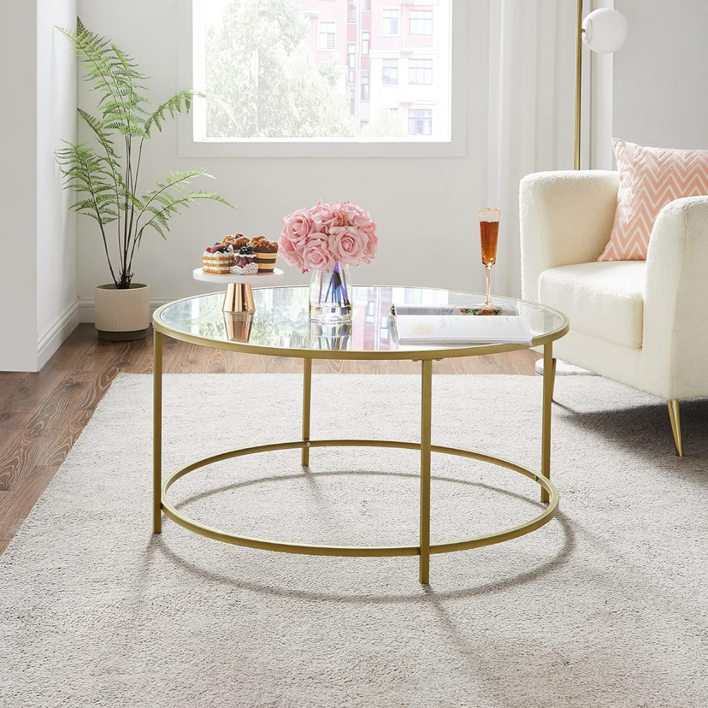 Living room with a gold coffee table, white sofa, and decorative items.