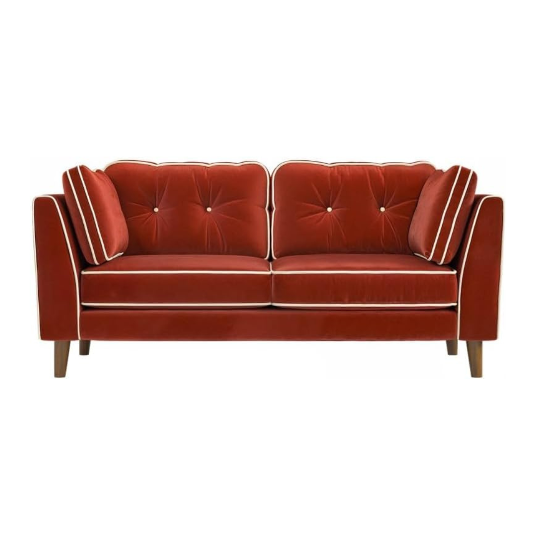 Red velvet sofa with tufted backrests on a white background
