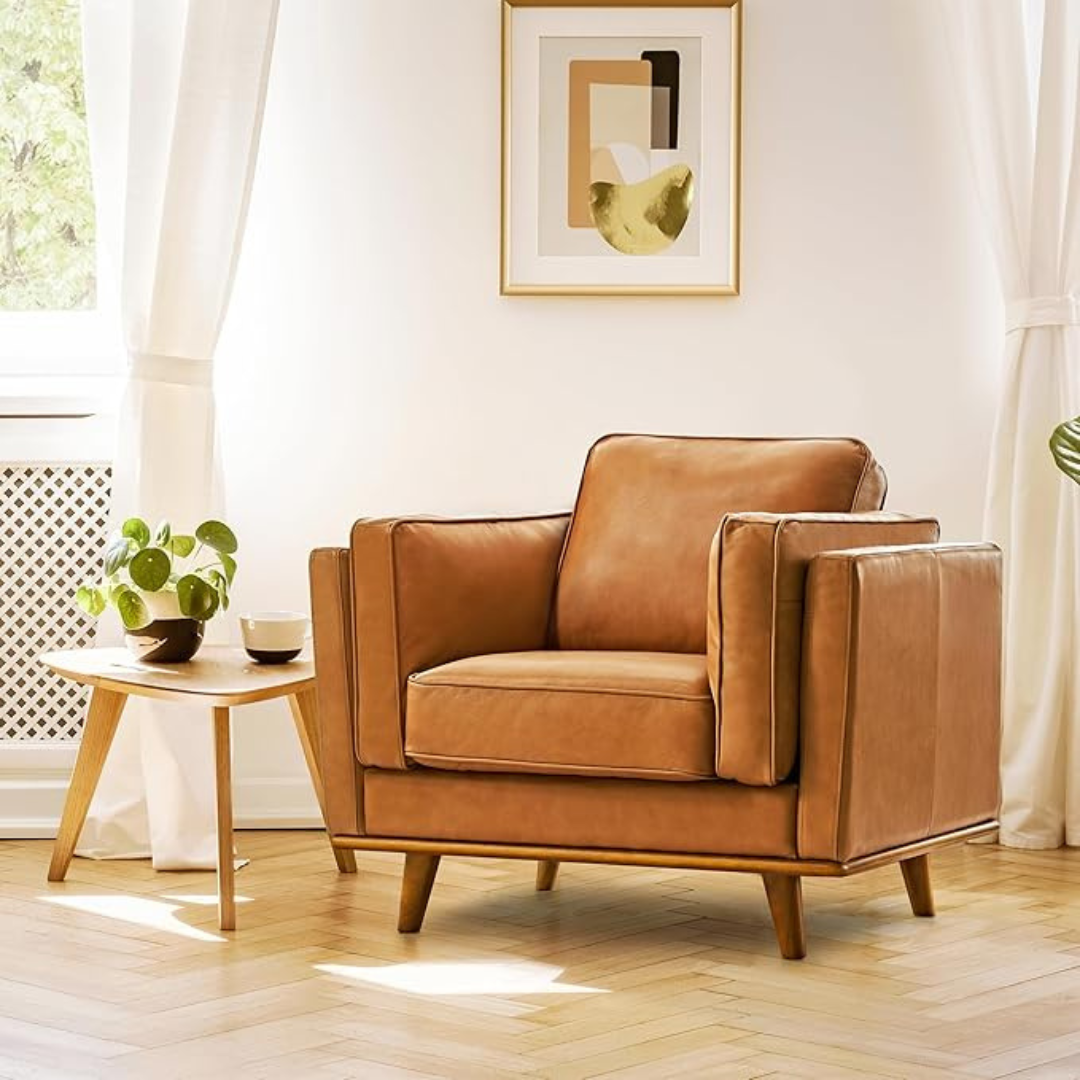 Brown leather armchair in a bright living room with a small table and plant.