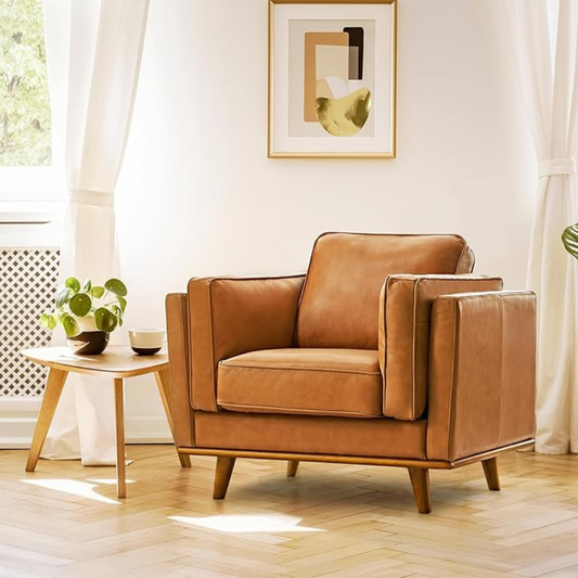 Brown leather armchair in a bright living room with a small table and plant.