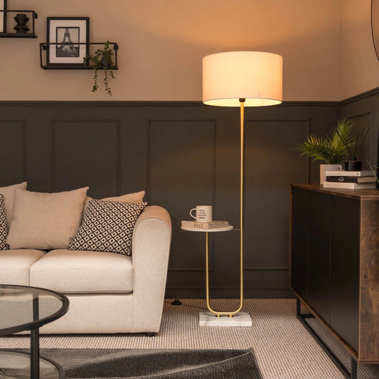 Modern living room with a beige sofa, floor lamp, and side table.