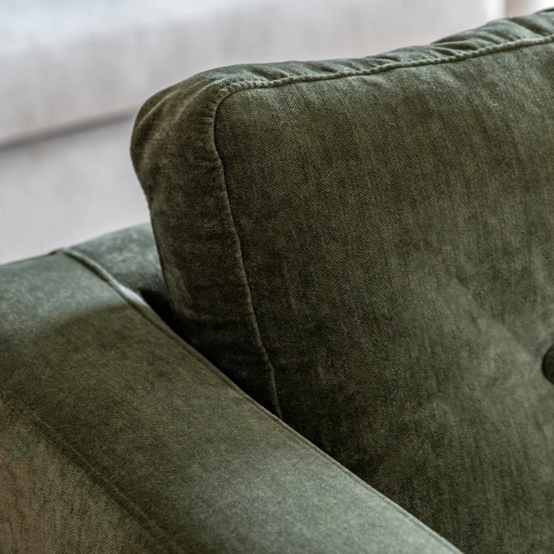Close-up of a green fabric surface with stitching details