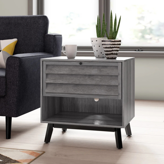 Modern Grey Bedside Table, set in a modern living room, angled view.
