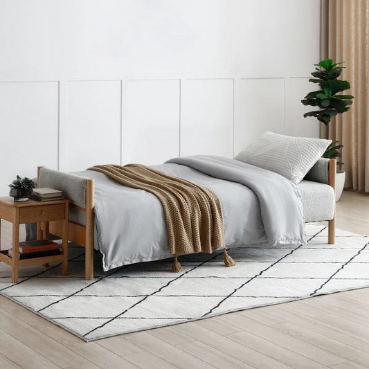 Modern Light Grey Sofa Bed Boucle, laid down as a bed in a modern home.