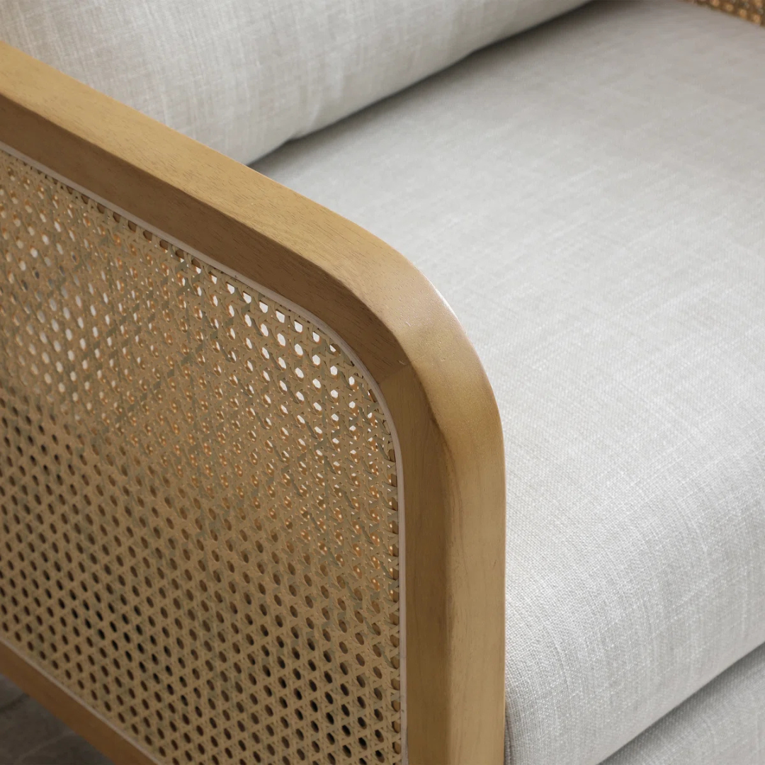 modern rattan armchair with curved wood arms and woven sides, close of rattan panels.
