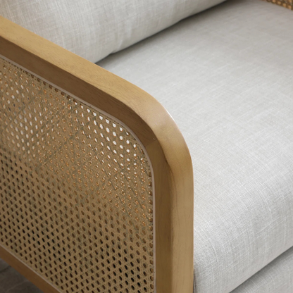 modern rattan armchair with curved wood arms and woven sides, close of rattan panels.