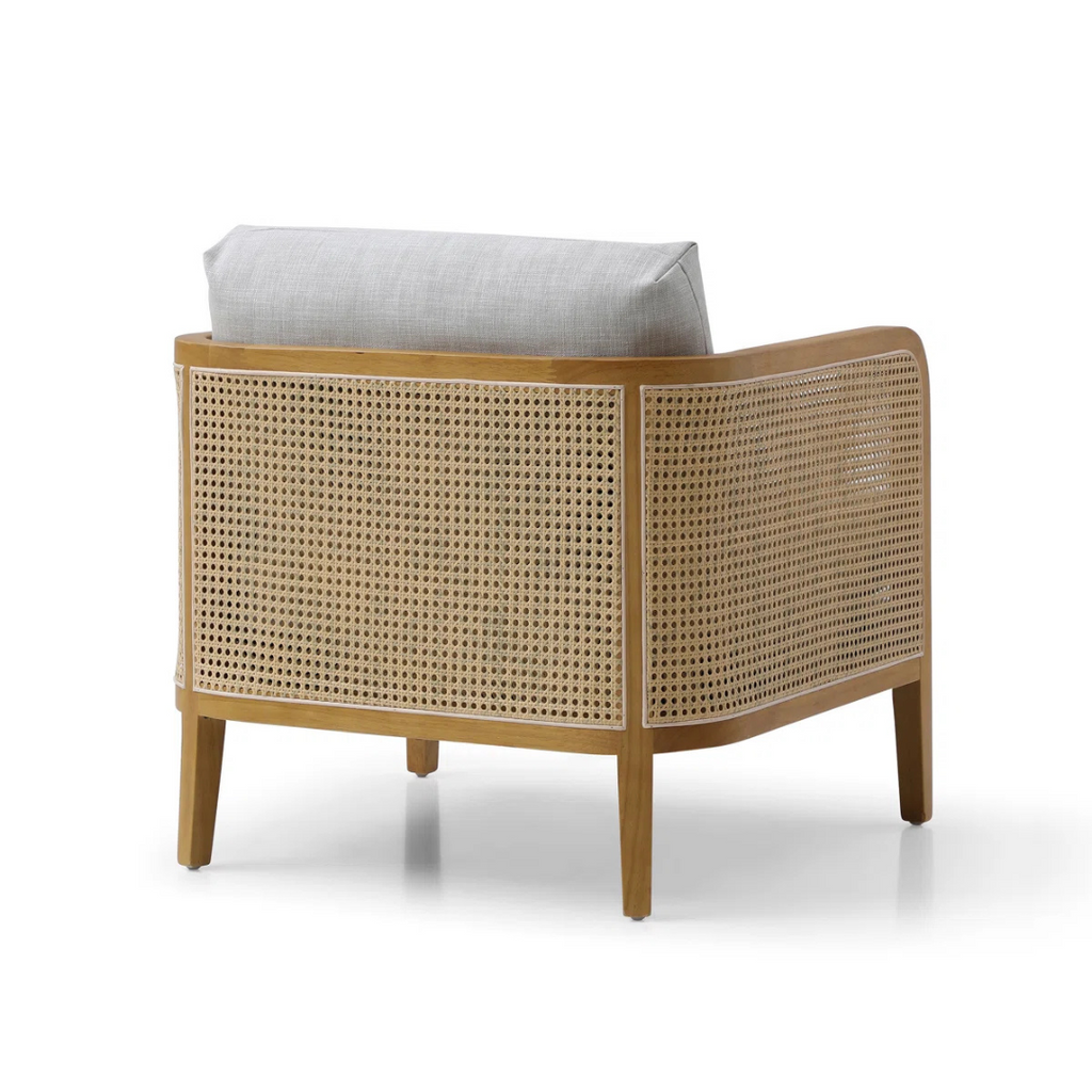 modern rattan armchair with curved wood arms and woven sides, white background, backview
