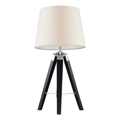 Table lamp with a white shade and black tripod base on a white background