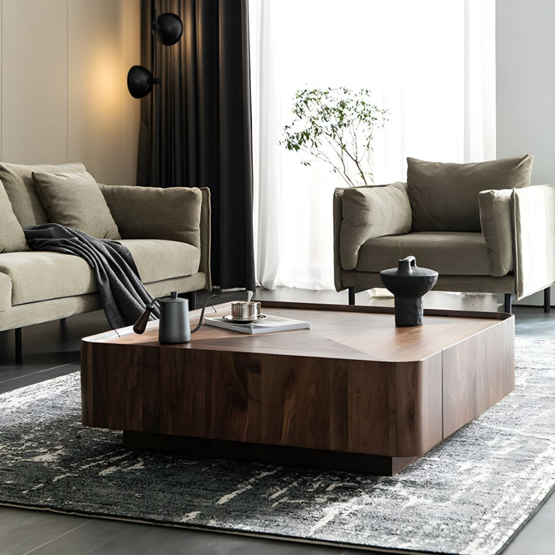 Modern walnut square coffee table with sculpted top in a living room setting, low angled view.
