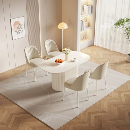 Modern White Oval Dining Room Table, with 4 dining chairs in a modern home.