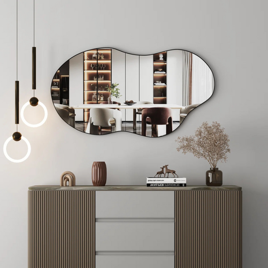 Modern interior design with an oval mirror, console table, and decorative items.