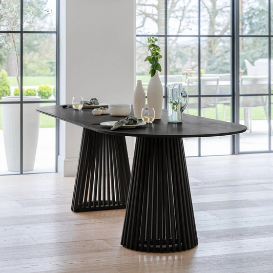 Modern Scandinavian Dining Table Black, set in a modern home, front view.